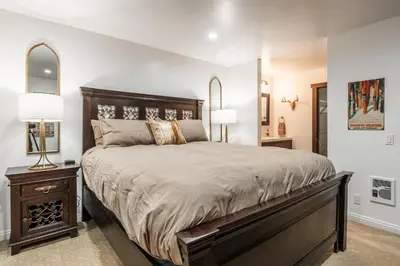 a bedroom with a large bed and a nightstand with two lamps at Summit 107 in Mammoth Lakes