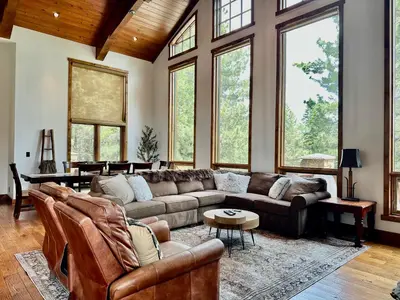 a large living room with couches and windows at Stonegate 12 in Mammoth Lakes