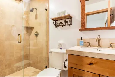 a bathroom with a shower and a toilet and a sink at Stonegate 12 in Mammoth Lakes