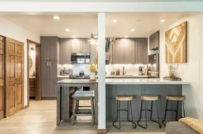 a kitchen with a large island with bar stools at Hidden Valley 33 in Mammoth Lakes