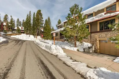 a snow covered street in front of a house at Magnolia Lodge 1 in Mammoth Lakes