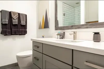 a bathroom with a toilet and a sink and a mirror at Mammoth Estates 233 in Mammoth Lakes