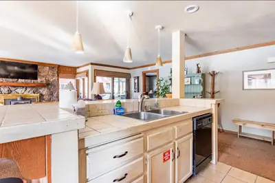 a kitchen with a sink and a counter at Alpine Glow Escape Big Windows & Views! in Mammoth Lakes