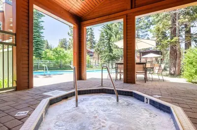 a jacuzzi tub in a house with a patio at Alpine Glow Escape Big Windows & Views! in Mammoth Lakes