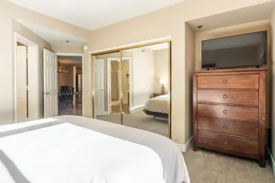 a bedroom with a bed and a dresser with a flat screen tv at Silver Bear 32 in Mammoth Lakes