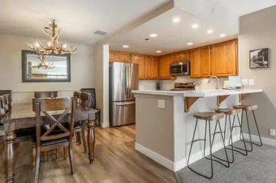 an open kitchen and dining room with a table and chairs at Silver Bear 32 in Mammoth Lakes