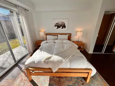 a bedroom with a large bed and a large window at Cozy Mammoth Ski Condo with Mtn Views and Hot Tub in Mammoth Lakes