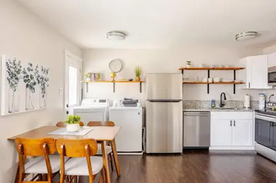 a kitchen with white appliances and a table and chairs at 719 Mid-Town Retreat in Reno