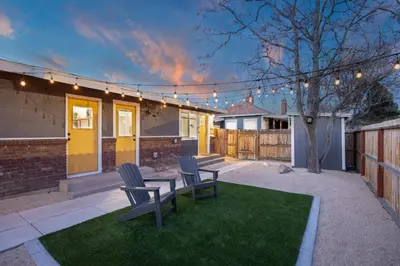 a backyard with two chairs and a table and a fence at 719 Mid-Town Retreat in Reno