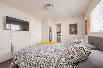 a bedroom with a bed with a blanket on it at 719 Mid-Town Retreat in Reno