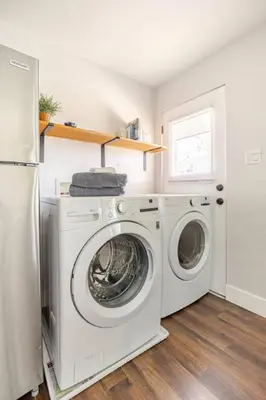 a laundry room with a washing machine and a refrigerator at 721 Cozy Mid-Town Hideaway in Reno