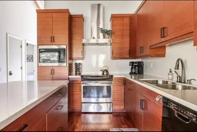 a kitchen with wooden cabinets and a stainless steel appliance at Chateau Blanc 21 in Mammoth Lakes