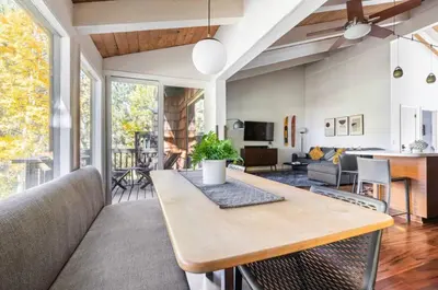 a living room with a table and a couch at Chateau Blanc 21 in Mammoth Lakes