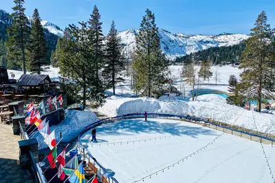an ice skating rink with people on it in the snow at Palisades Tahoe Ski Getaway with Pool and Lift Access! in Olympic Valley
