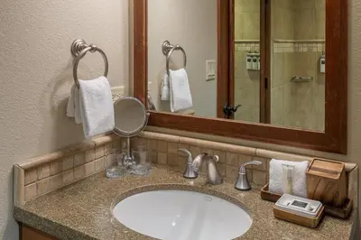 a bathroom with a sink and a mirror at Ski-InandSki-Out! 2BR Condo with Resort Pools, Spa in Olympic Valley