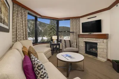 a living room with a couch and a fireplace at Ski-InandSki-Out! 2BR Condo with Resort Pools, Spa in Olympic Valley