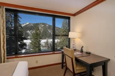 a bedroom with a desk and a window with a mountain view at Valley Vistas, Resort Perks Everline Studio Condo in Olympic Valley