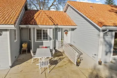 a small white house with a table and chairs at Spacious 6 BR • Patio + Deck • Sleeps 13 in Sacramento