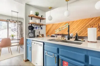 a kitchen with blue cabinets and white counter tops at Snowcreek 1 in Mammoth Lakes