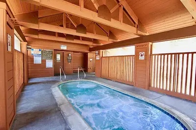 an indoor swimming pool in a building with wooden walls at Snowcreek 1 in Mammoth Lakes