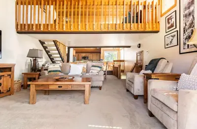 a living room with a couch and a table at Snowcreek 222 in Mammoth Lakes