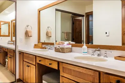 a bathroom with two sinks and a large mirror at Snowcreek 222 in Mammoth Lakes