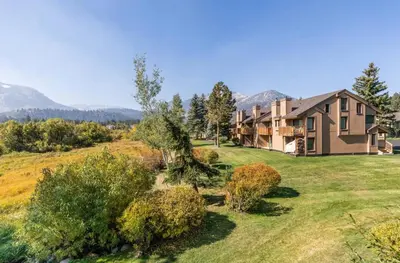 a large house on a hill with a yard at Snowcreek 222 in Mammoth Lakes