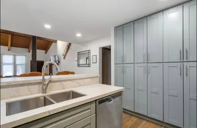a kitchen with a sink and white cabinets at St. Moritz 39 in Mammoth Lakes