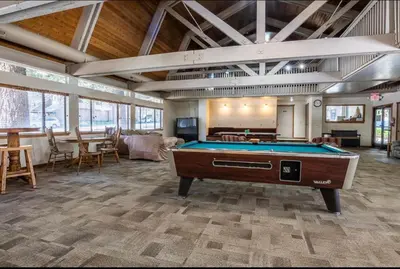 a large room with a pool table in it at St. Moritz 39 in Mammoth Lakes