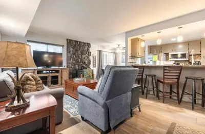a living room with a couch and a kitchen at Sunshine Village 145 in Mammoth Lakes