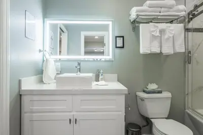 a bathroom with a sink and a toilet and a mirror at Chateau Blanc 1 in Mammoth Lakes