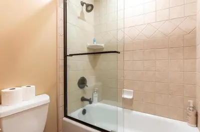 a bathroom with a shower with a tub and a toilet at Western Slopes Villas 18 in Mammoth Lakes