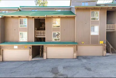 a building with two garage doors in a parking lot at Western Slopes Villas 18 in Mammoth Lakes