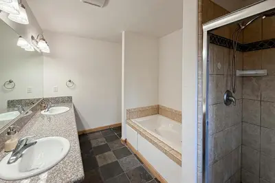 a bathroom with two sinks and a shower at High Sierra Hideaway in South Lake Tahoe