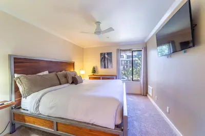a bedroom with a large white bed and a window at Quaint 1B/1BA Canyon Lodge Condo: Jacuzzi & More! in Mammoth Lakes