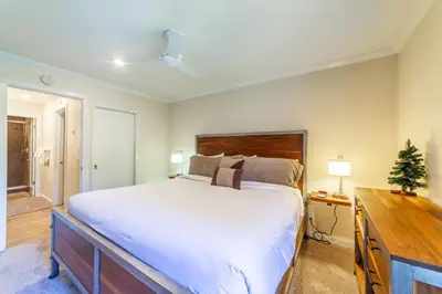 a bedroom with a large bed and a christmas tree at Quaint 1B/1BA Canyon Lodge Condo: Jacuzzi & More! in Mammoth Lakes