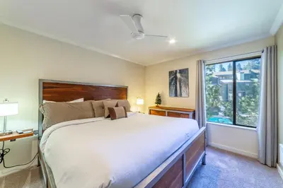 a bedroom with a large bed and a window at Quaint 1B/1BA Canyon Lodge Condo: Jacuzzi & More! in Mammoth Lakes