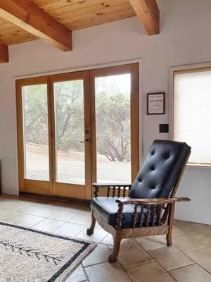 a black leather chair in a room with a window at Casa Manzanita in Midpines! 26 miles to Yosemite! in Midpines