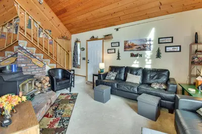 a living room with a couch and a table at Deck and Wooded Views 5-Acre Auberry Retreat! in Auberry