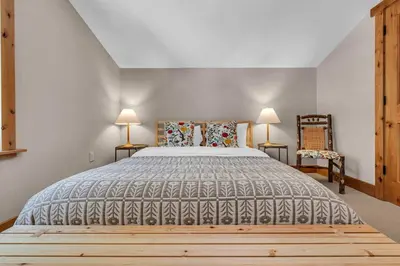 a bedroom with a large bed and two lamps at Cozy Tahoe Getaway - Walk to Lake & Quiet Deck in Carnelian Bay