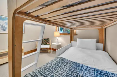 a bed in a small room with a bunk bed at Cozy Tahoe Getaway - Walk to Lake & Quiet Deck in Carnelian Bay