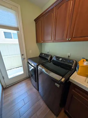 a small kitchen with a washer and a window at Spacious 5-bedroom 3-bath house in NW Fresno in Fresno