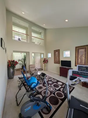 a living room with a gym with a treadmill at Spacious 5-bedroom 3-bath house in NW Fresno in Fresno