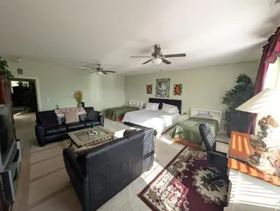 a living room with a couch and a bed at Spacious 5-bedroom 3-bath house in NW Fresno in Fresno