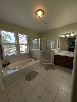 a large bathroom with a tub and a shower at Spacious 5-bedroom 3-bath house in NW Fresno in Fresno