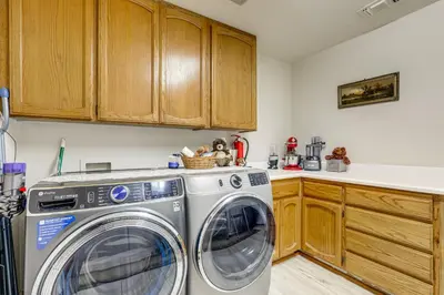 a kitchen with a washer and dryer at Hot Tub and Huge Patio Home 5 Mi to Old Town Auburn in Auburn