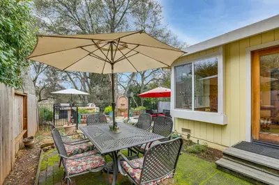 a patio with a table and chairs and an umbrella at Hot Tub and Huge Patio Home 5 Mi to Old Town Auburn in Auburn