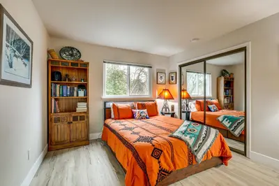 a bedroom with two beds and a large mirror at Hot Tub and Huge Patio Home 5 Mi to Old Town Auburn in Auburn