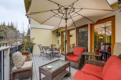 a patio with a table and an umbrella at Hot Tub and Huge Patio Home 5 Mi to Old Town Auburn in Auburn
