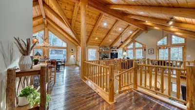 a log home with a wooden ceiling at Truckee Mountain Cabin with Hot Tub Game Room Forest Views Gray Wolf Lodge by AvantStay in Truckee